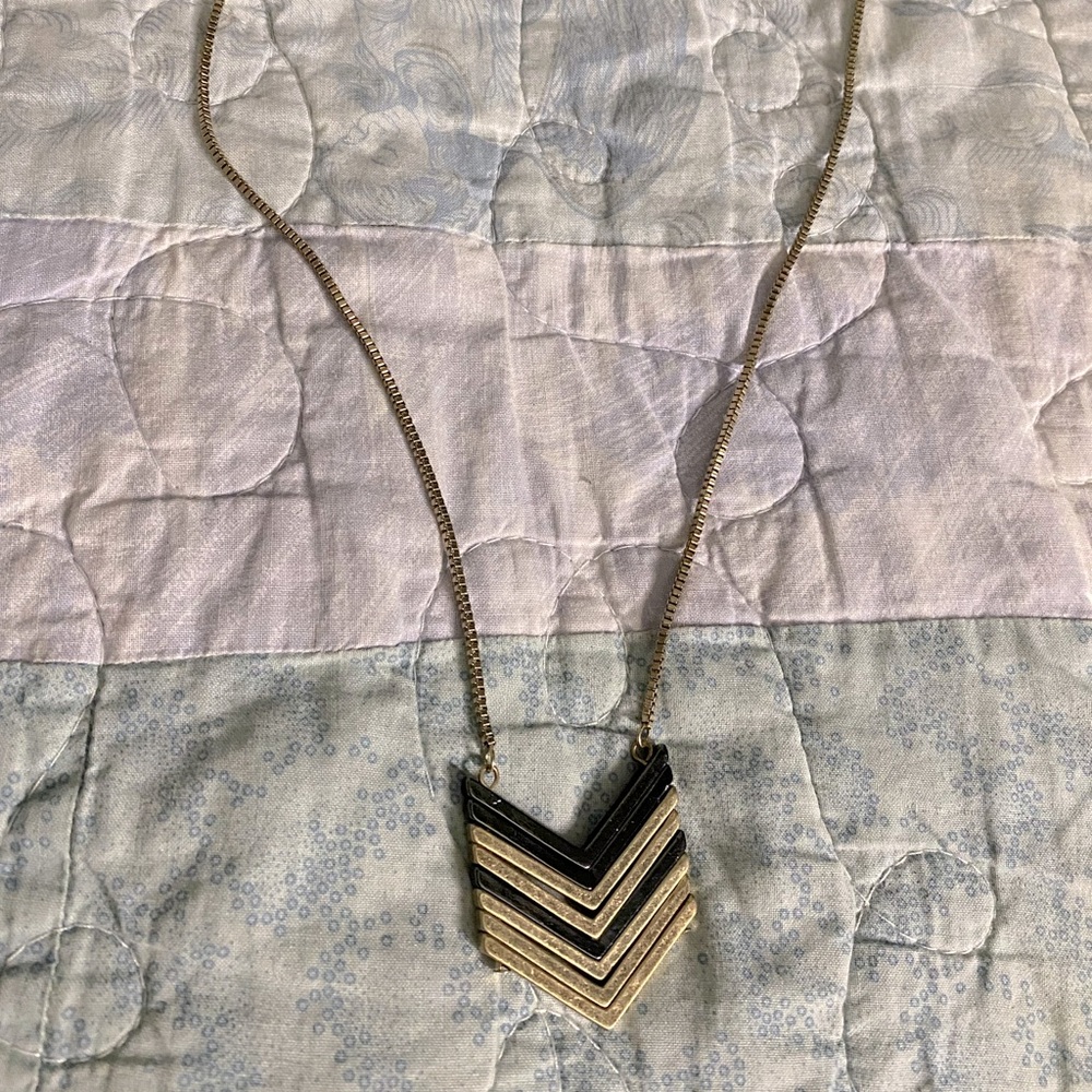 Gold and black arrow design necklace
